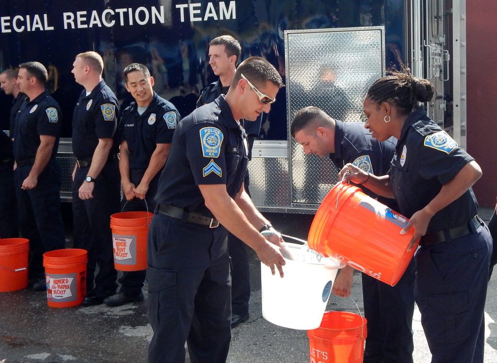 Sergeant Lakeisha Phelps and colleagues at the Nashua, NH police department participated in an ice-bucket challenge to raise awareness for ALS, in August, 2014. Phelps is one of two black police officers in a force of 170. (Credit: Dean Shalhoup/ Nashua Telegraph)