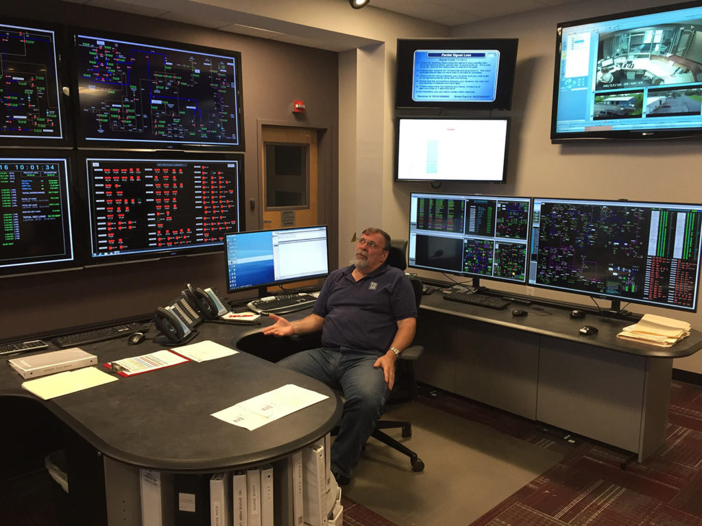 Vermont Electric Cooperative's Dan McMullen keeps a close eye on screens that show the electrons flowing in and out of the co-op's northern Vermont territory. Credit: John Dillon/VPR