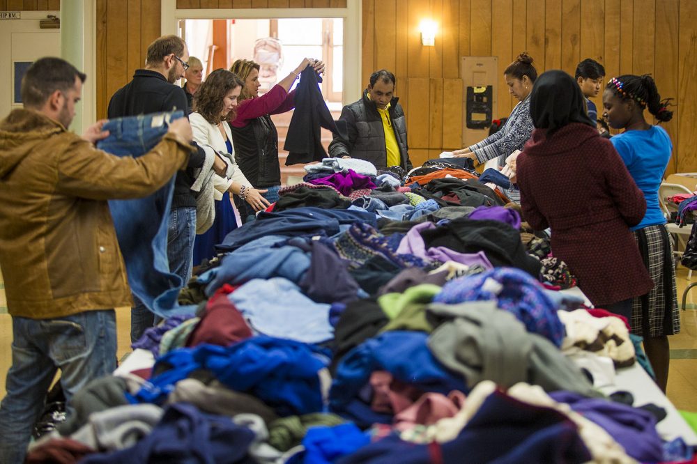 Refugees pick out items at a clothing drive at First United Baptist Church in Lowell. Credit: Jesse Costa / WBUR