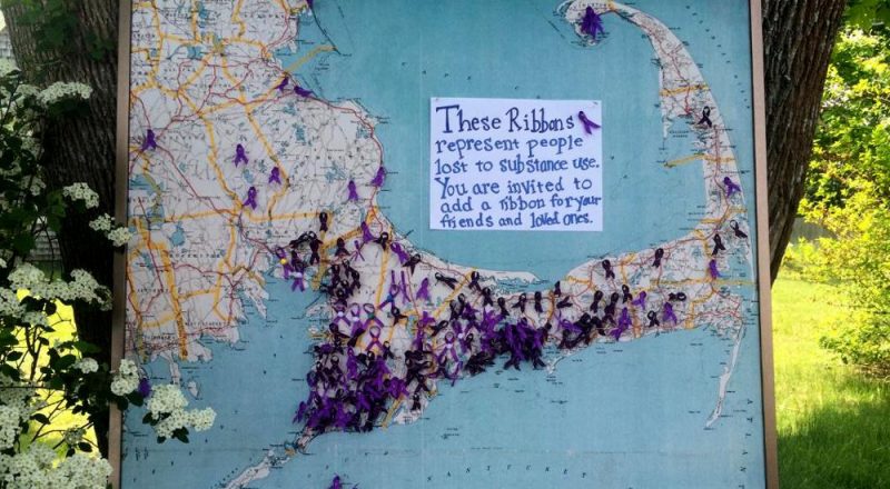 A map of Cape Cod with ribbons representing those lost to substance abuse at the AIDS Support Group of Cape Cod. (Credit: Ryan Sweikert)