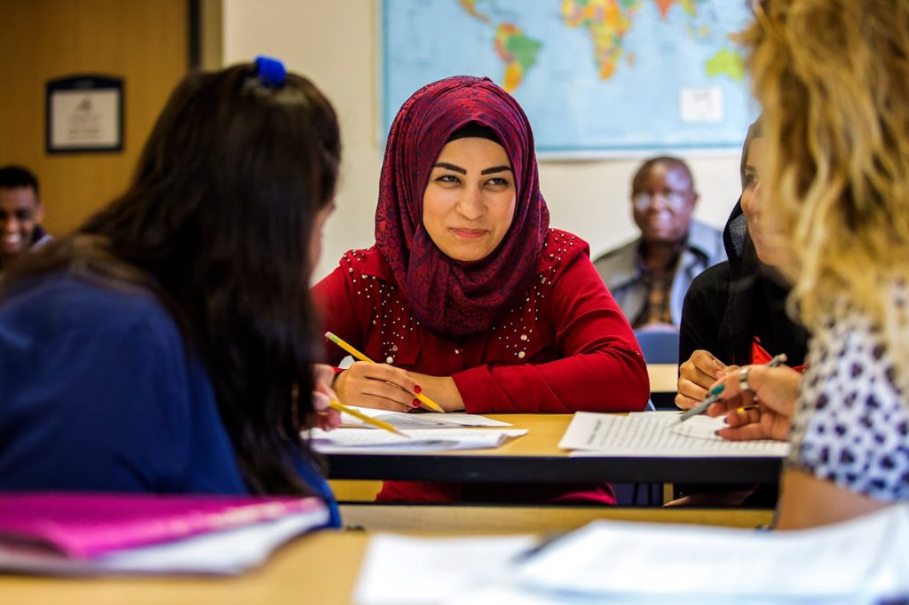 Zainab Khalil Abdo spends time with other students in an English for Speakers of Other Languages (ESOL) class in Lowell, Mass. ( Credit: Jesse Costa/WBUR)