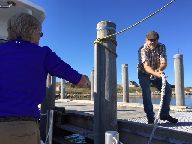 Island caretaker Weston Lant helps clinical director Coco Wellington ease into the dock. Photo credit: Karen Brown / NEPR