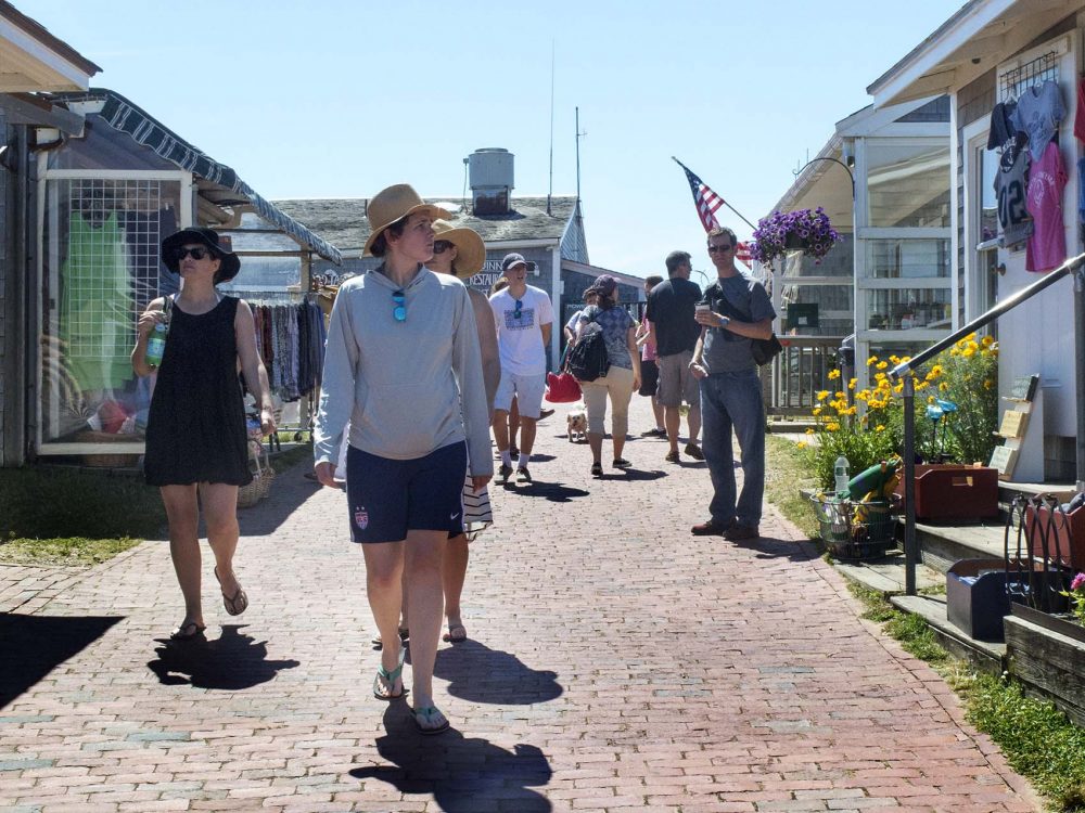 Tourists walk through the Shops at Aquinnah, part of the newly established Aquinnah Cultural District on Martha's Vineyard. (Credit: Andrea Shea/WBUR)