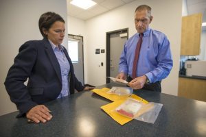 Arlington Police Chief Fred Ryan, right, and inspector Gina Bassett review toxicology reports on cocaine evidence, looking for the possibility of fentanyl. "Law enforcement tells us that the next wave of the addiction crisis is fentanyl-laced cocaine," Ryan says. Photo by Jesse Costa for WBUR