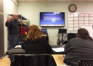 Director John Burns of SOS Recovery teaches a training on "compassion fatigue" in Dover. (Paige Sutherland/NHPR)