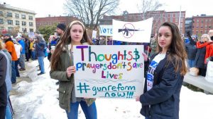 Two marchers outside the State House. (Sean Hurley/NHPR)