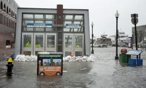 Sandbags hold back water at the entrance to the Aquarium MBTA station during the March 2 nor'easter. Photo by Robin Lubbock for WBUR