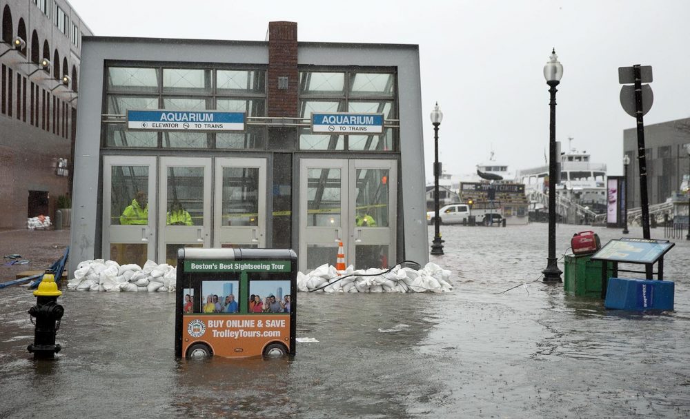 Sandbags hold back water at the entrance to the Aquarium MBTA station during the March 2 nor'easter. Photo by Robin Lubbock for WBUR