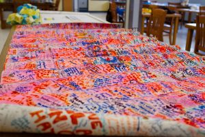 Items from a pop-up memorial following the 2013 Boston Marathon bombing are arranged on tables in the Boston City Archives reading room five years later. Photo by Elizabeth Gillis for WBUR