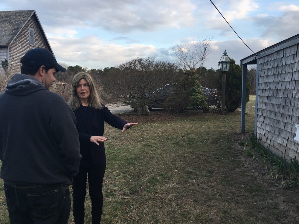 Wescley Pereira and Gail Meister chat about a yard project. The two have been neighbors on Martha’s Vineyard for more than a decade. Photo by Shannon Dooling for WBUR.