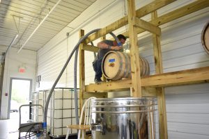 Steve Gagner fills one of the first barrels of bourbon from Danger Close Craft Distilling. Courtesy of Danger Close Craft Distilling