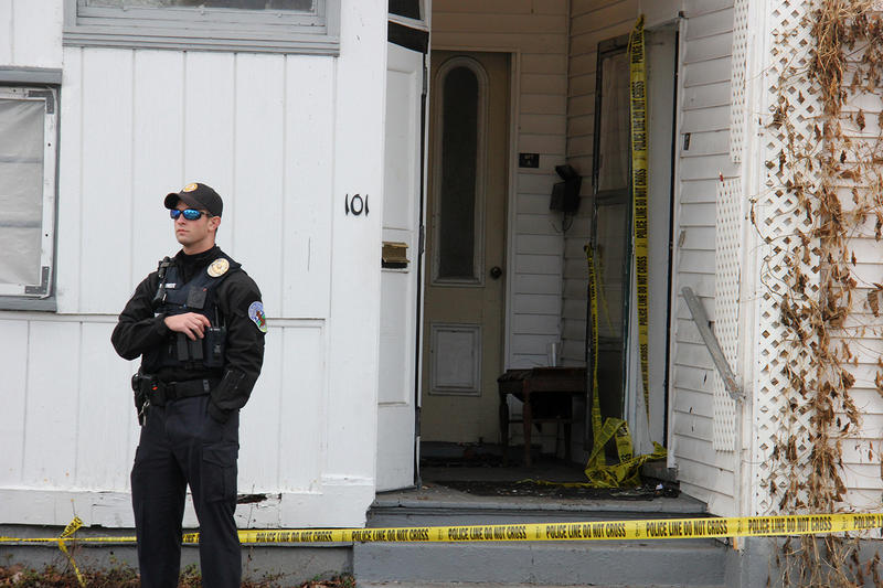 A Burlington Police Officer keeps watch outside a building. Photo by Taylor Dobbs for VPR