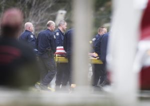 The body of Somerset County Sheriff's Deputy Eugene Cole is brought out and loaded into a medical examiner's van on Wednesday, April 25, 2018. Photo by Kevin Bennet for Maine Public