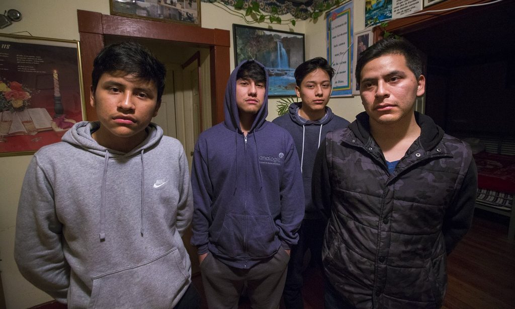 Isidro Macario, 27 right, wes brought here as a young child from Guatamala is facing deportation potentially making him leave behind the rest of his family, (l-r) Saul, 16, Anthony, 18 and Erwin, 21, who were born in the United States. (Jesse Costa/WBUR)