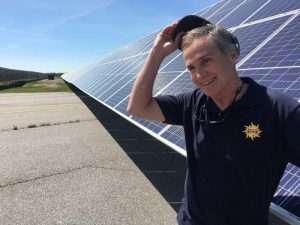 Steve Hinchman of ReVision Energy at the 1.5 megawatt solar plant the company installed at Brunswick Landing. Photo by Fred Bever for Maine Public