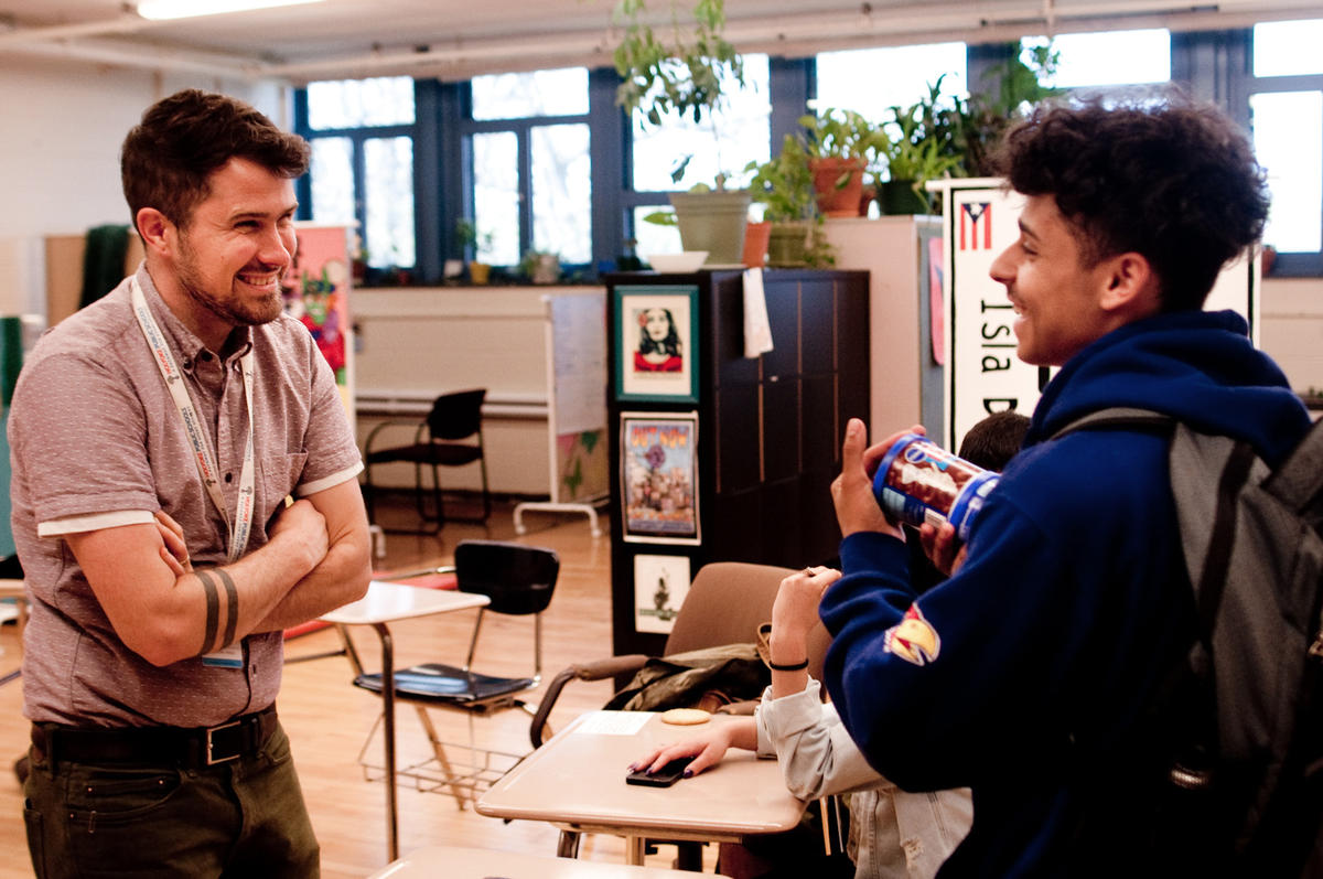 Pa'lante director Luke Woodward speaks with peer leader David Serrano, a sophomore, in the student support room. Photo by Ben James for NEPR