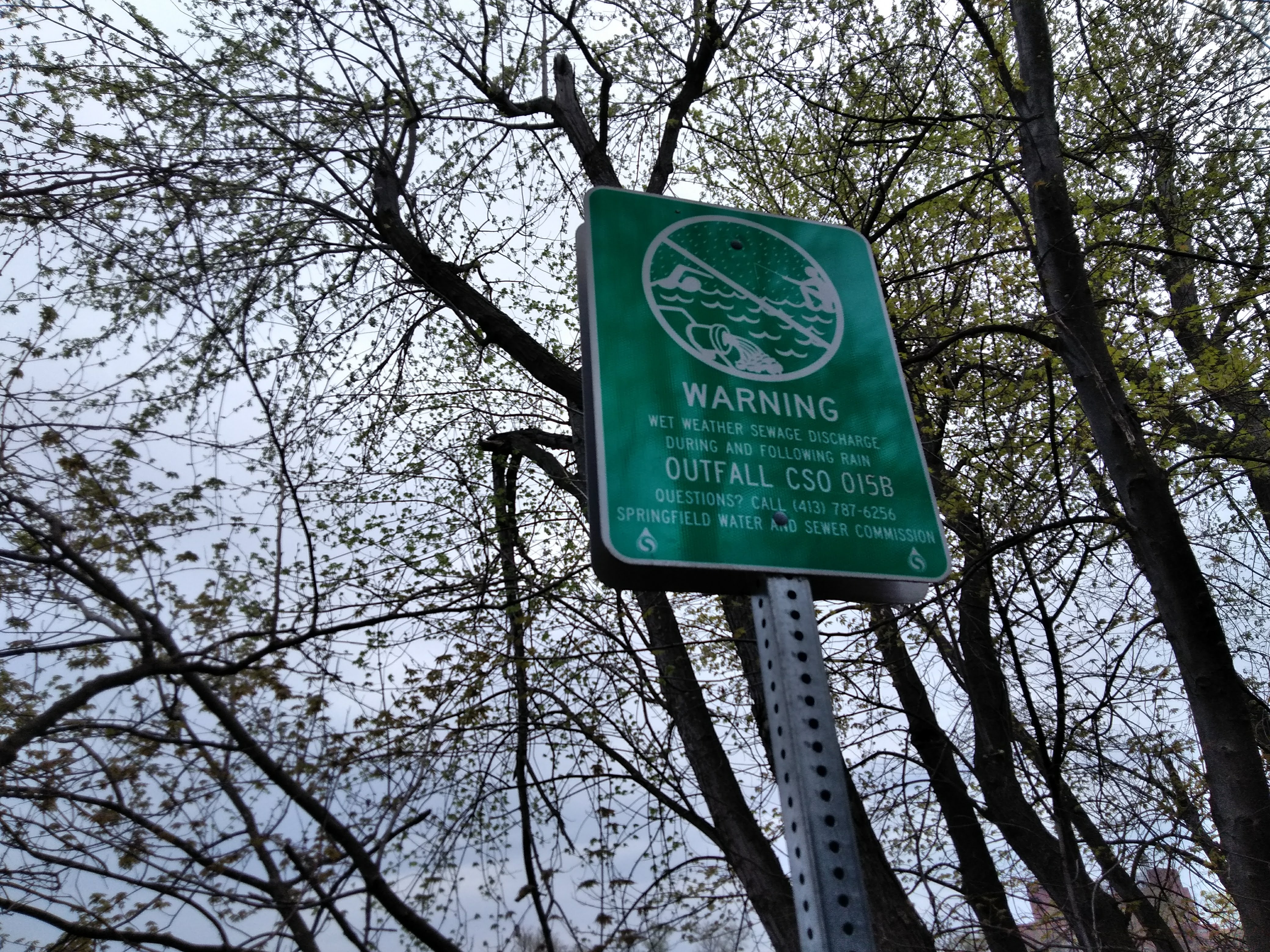 A sign along the Connecticut River warns of sewage discharge during and following rain. Photo by Jill Kaufman for NEPR