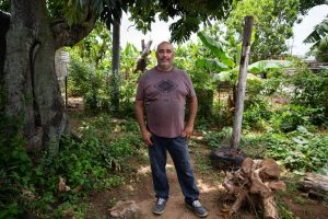 Hurricane Maria destroyed Ramón Luis Morales's roof, but he hasn't been able to finish rebuilding because he's still waiting on supplies. In the meantime, he's helping another man in need fix his house. Photo by Ryan Caron King for Connecticut Public Radio