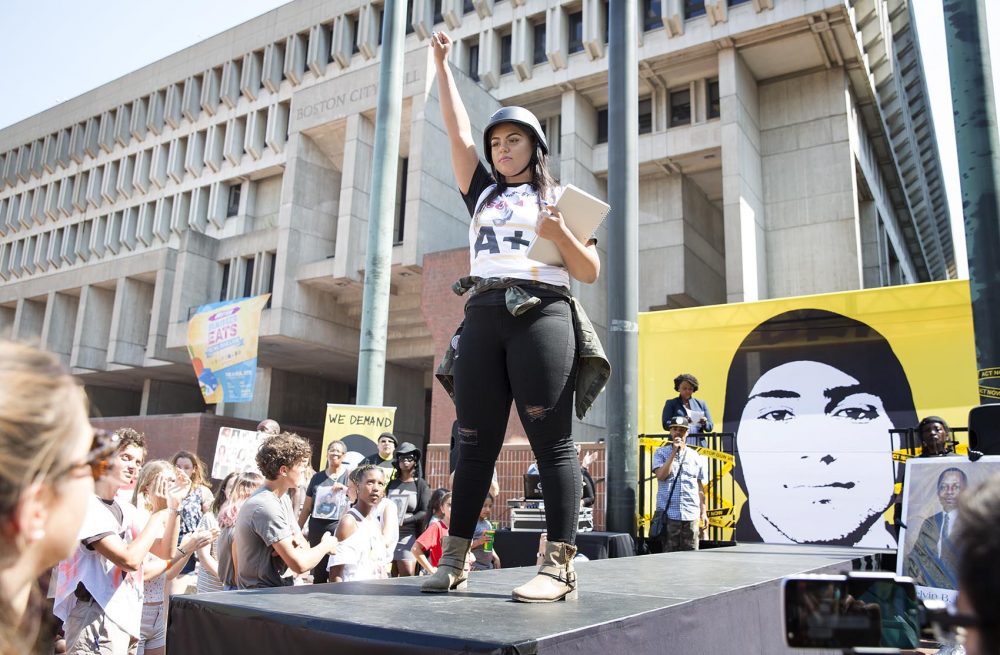 A student models a military helmet at the Back To School fashion show in City Hall Plaza on Monday. Photo by Robin Lubbock for WBUR