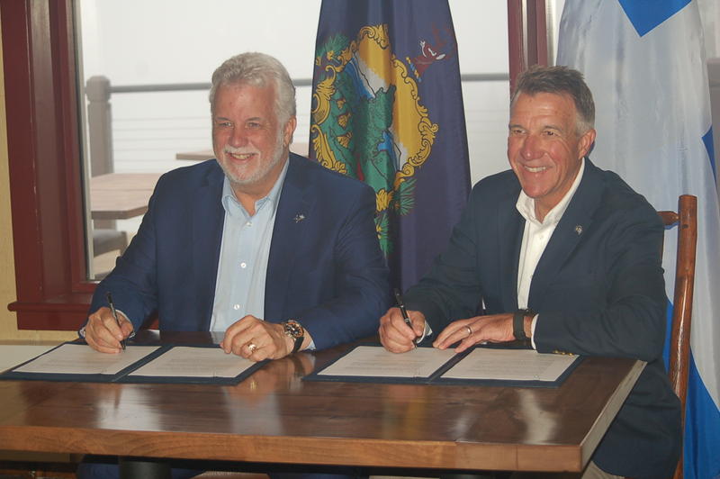 Quebec Premier Philippe Couillard, left, and Vermont Gov. Phil Scott Sunday signed a bilateral agreement pledging continuing cooperation on a host of cross-border issues. Photo by John Dillon for VPR