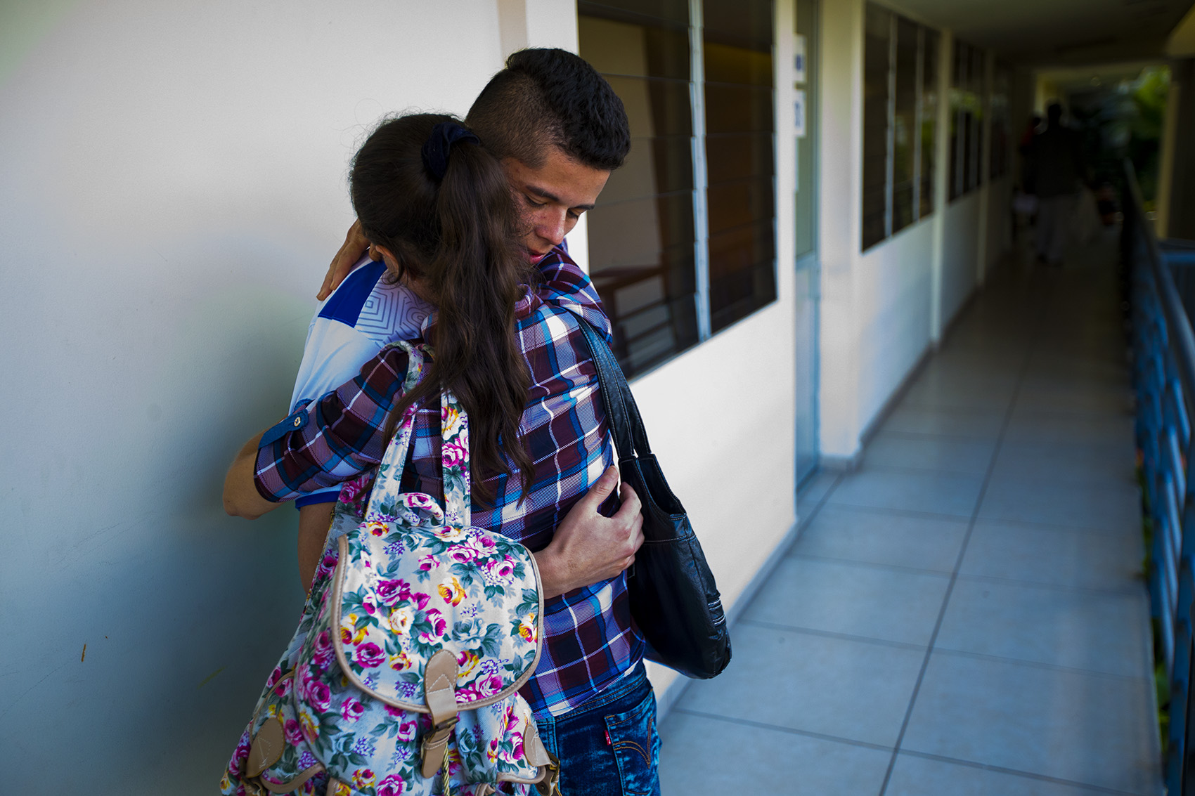 A 21-year-old man deported from Boston is reunited with his mother at the Centro de Atención integral a Migrante (Comprehensive Migrant Care Center) in San Salvador. Photo by Jesse Costa for WBUR