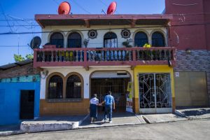 A couple walk hand-in-hand into Panaderia Pacita Quintanilla in San Vicente, El Salvador. Photo by Jesse Costa for WBUR