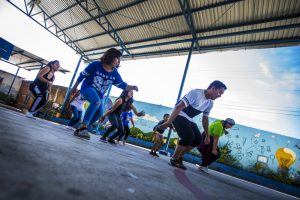 Volunteers for Glasswing International lead members of the Glee club in a dance routine at a school in Las Palmas, San Salvador, El Salvador. Photo by Jesse Costa for WBUR