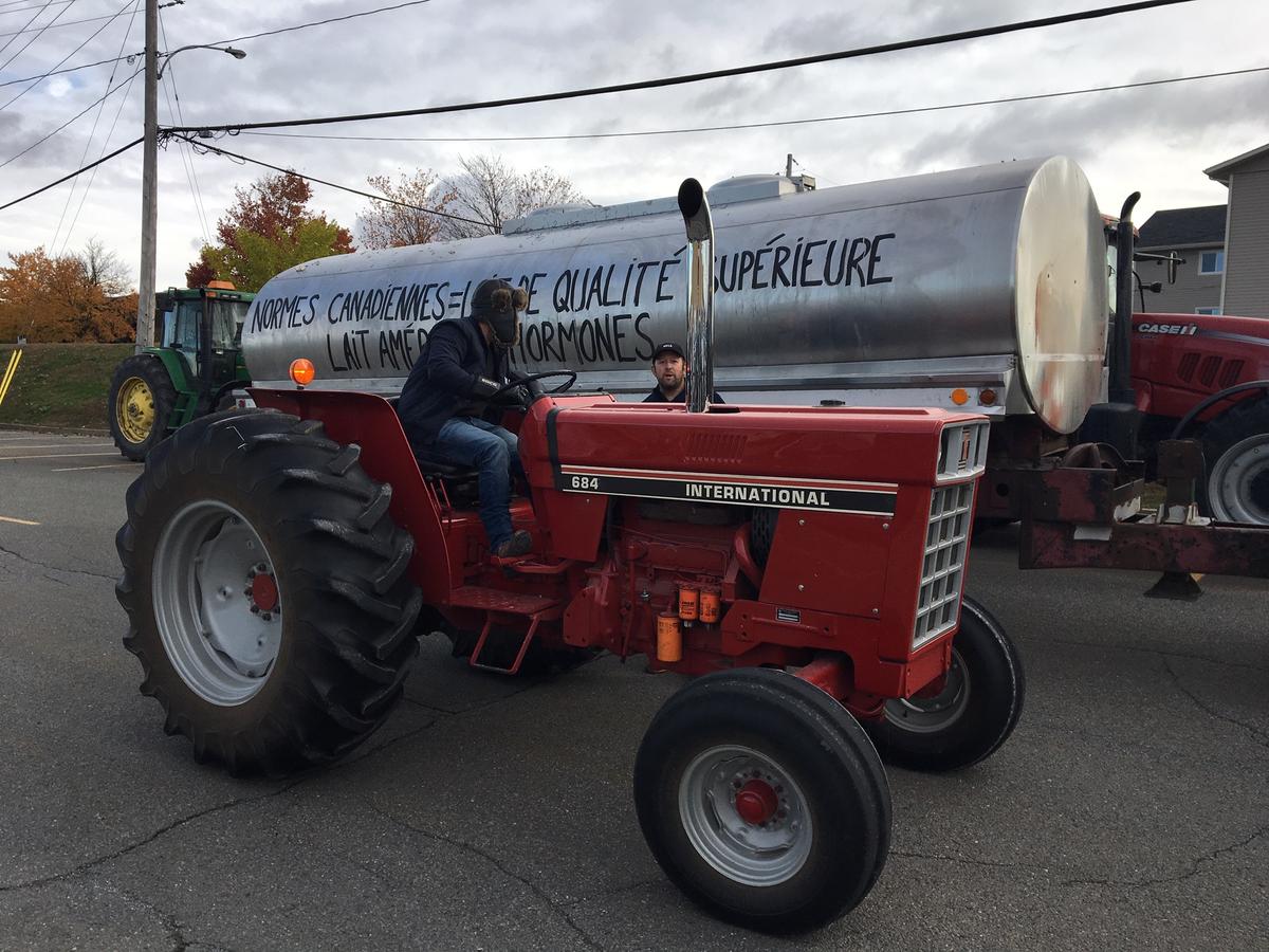 Farmers led a tractor parade down the streets of Granby, Quebec to protest the new trade deal. Photo by John Dillon for VPR