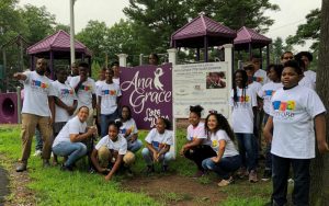 Members of the Greater Hartford Youth Leadership Academy take a photo with Nelba Marquez-Greene, kneeling at right, before boarding a bus headed to a rally in Newtown, Conn. Marquez-Greene's daughter Ana died in the Newtown school shooting. Photo by Vanessa de la Torre for Connecticut Public Radio