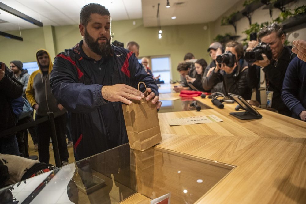 Veteran Steven Mandile make the first purchase of recreational marijuanain Massachusetts at Cultivate in Leicester. Photo by Jesse Costa for WBUR