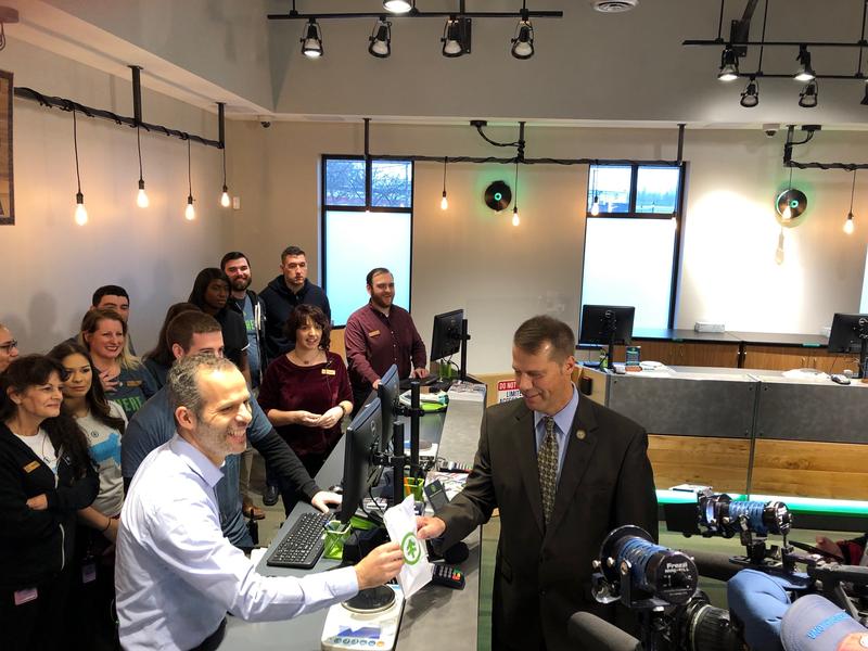 Northampton Mayor David Narkewicz makes the first purchase at NETA from co-owner Arnon Vered on Tuesday. Photo by Alden Bourne for NEPR