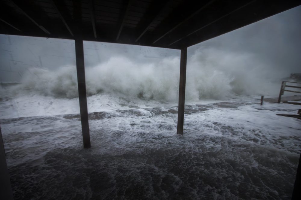 Waves crash along teh seawall on Oceanside Road in Scituate. Photo by Jesse Costa for WBUR