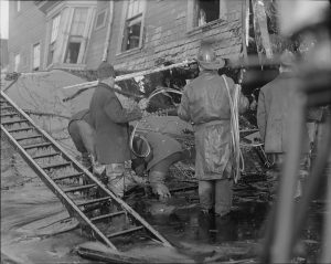 Firemen standing in thick molasses after the disaster. Courtesy of the Boston Public Library, Leslie Jones Collection.