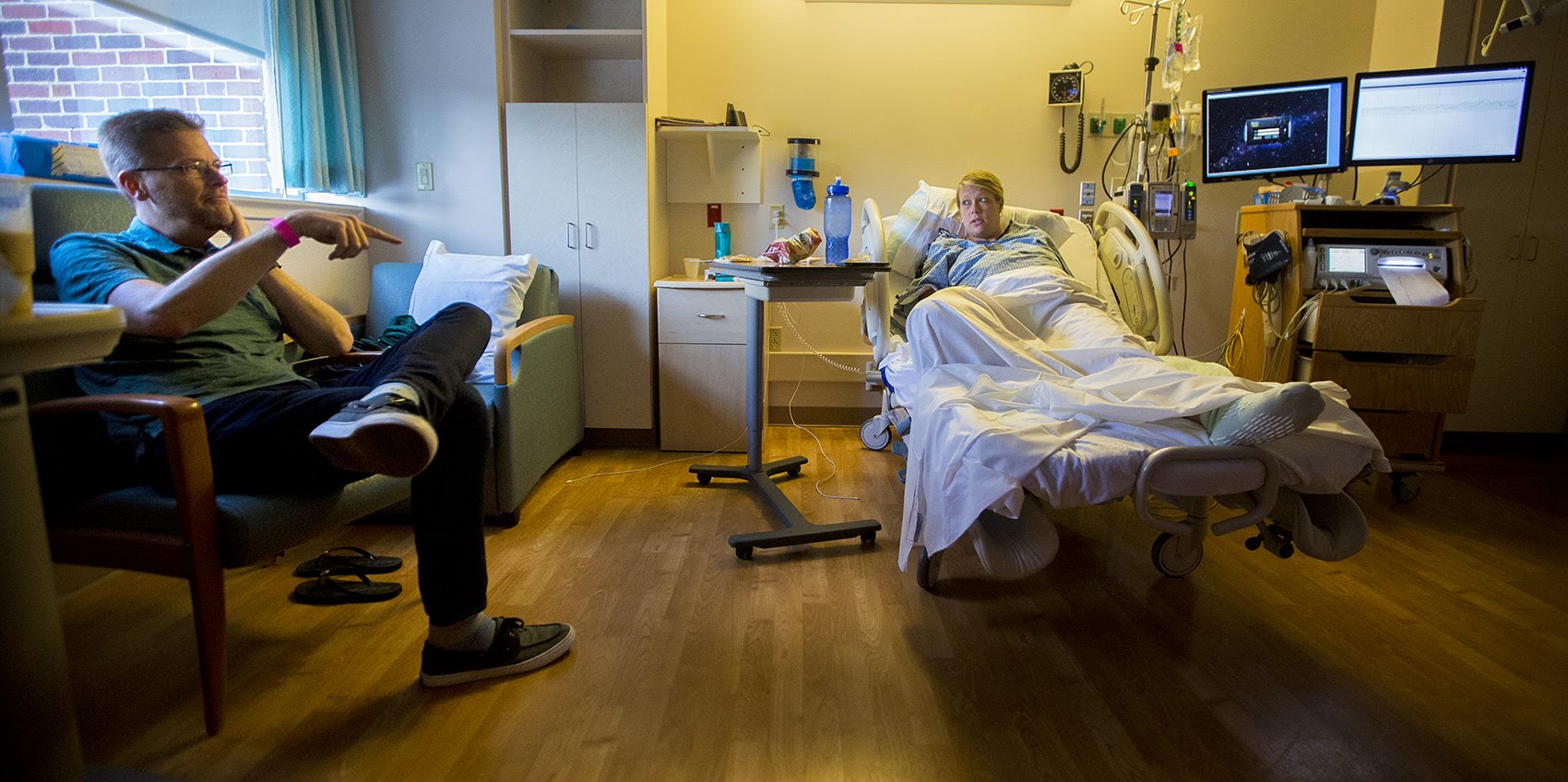 Shaun and Melisa McDougall, of Hanover, are checked into South Shore Hospital where Melisa will deliver twin boys. They don't want a C-section, which fits the goals of Ariadne Lab's Team Birth Project, now in the testing phase at South Shore. Photo by Jesse Costa for WBUR