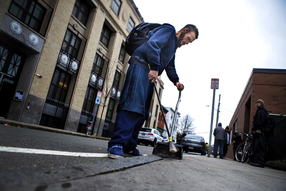 Michael sweeping up cigarettes and other debris from the sidewalk outside the ACC Needle Exchange in Central Square in Cambridge. Photo by Jesse Costa for WBUR