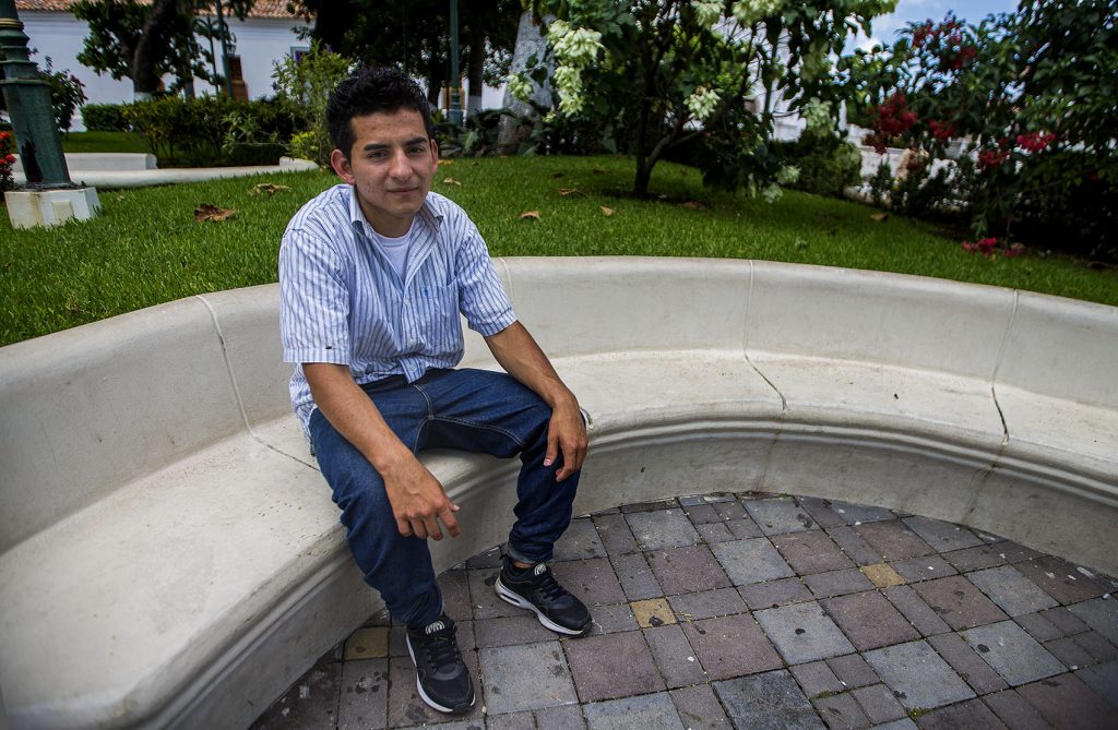 Orlando sits in a plaza in Metapán, El Salvador. Photo by Jesse Costa for WBUR