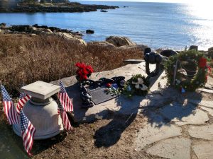 Flowers and wreaths adorn a naval anchor honoring President George H.W. Bush on a bluff overlooking Walker's Point in Kennebunkport on Saturday, Dec. 1, 2018. Photo by Irwin Gratz for Maine Public