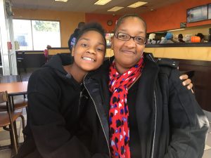 Kennekca Kindell (right) and her 14-year-old daughter, Kanija Kindell, visit the Dunkin' Donuts in Pawtucket where Kennekca works. Photo by Avory Brookins for The Public's Radio