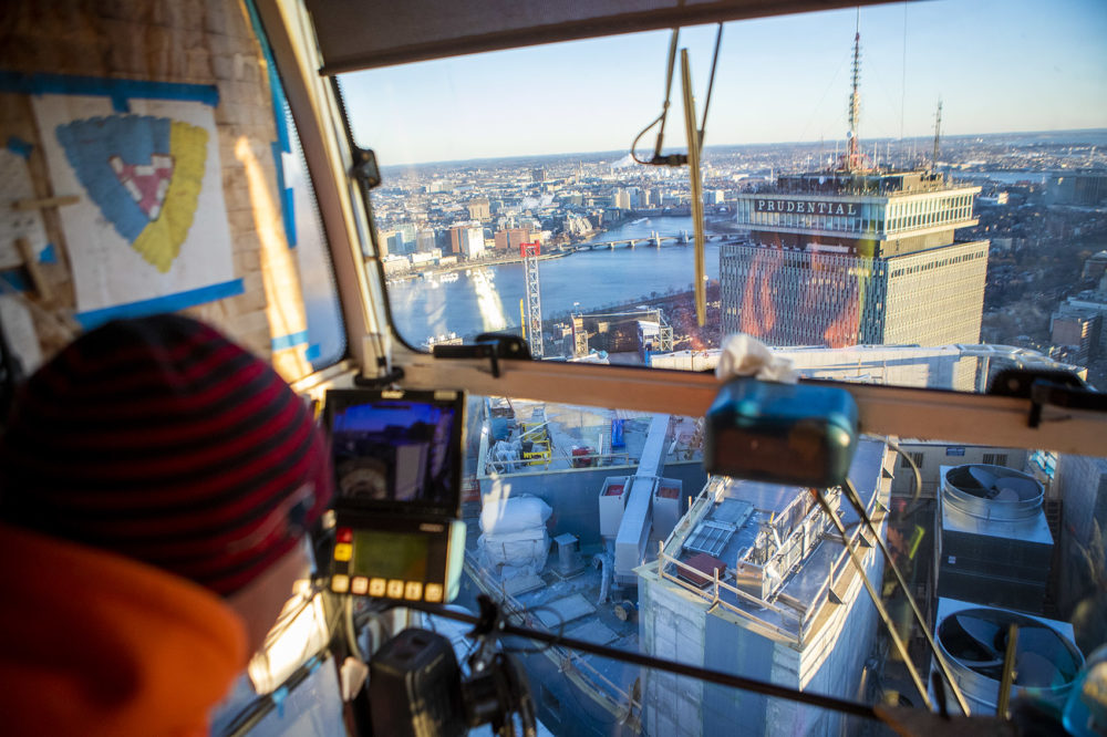 A rare view, looking down at the Prudential Center, as Brett St.Germain operates the crane which sits above One Dalton Street. Photo by Jesse Costa for WBUR