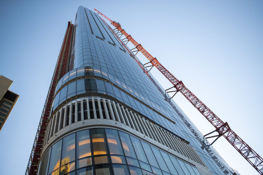 Thew crane's mast extends all the way up the side of One Dalton Street. Photo by Jesse Costa for WBUR