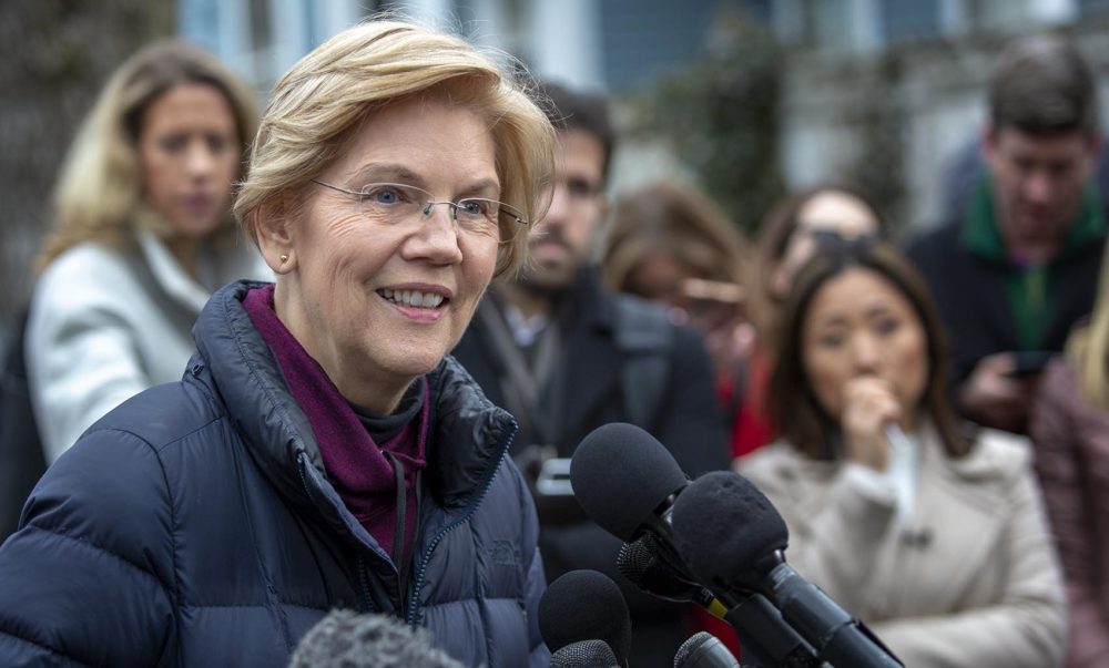 Massachusetts senator Elizabeth Warren talks with reporters outside her home in Cambridge Mass. after announcing that she is setting up an exploratory committee for a run for the presidency in 2020. Photo by Robin Lubbock for WBUR