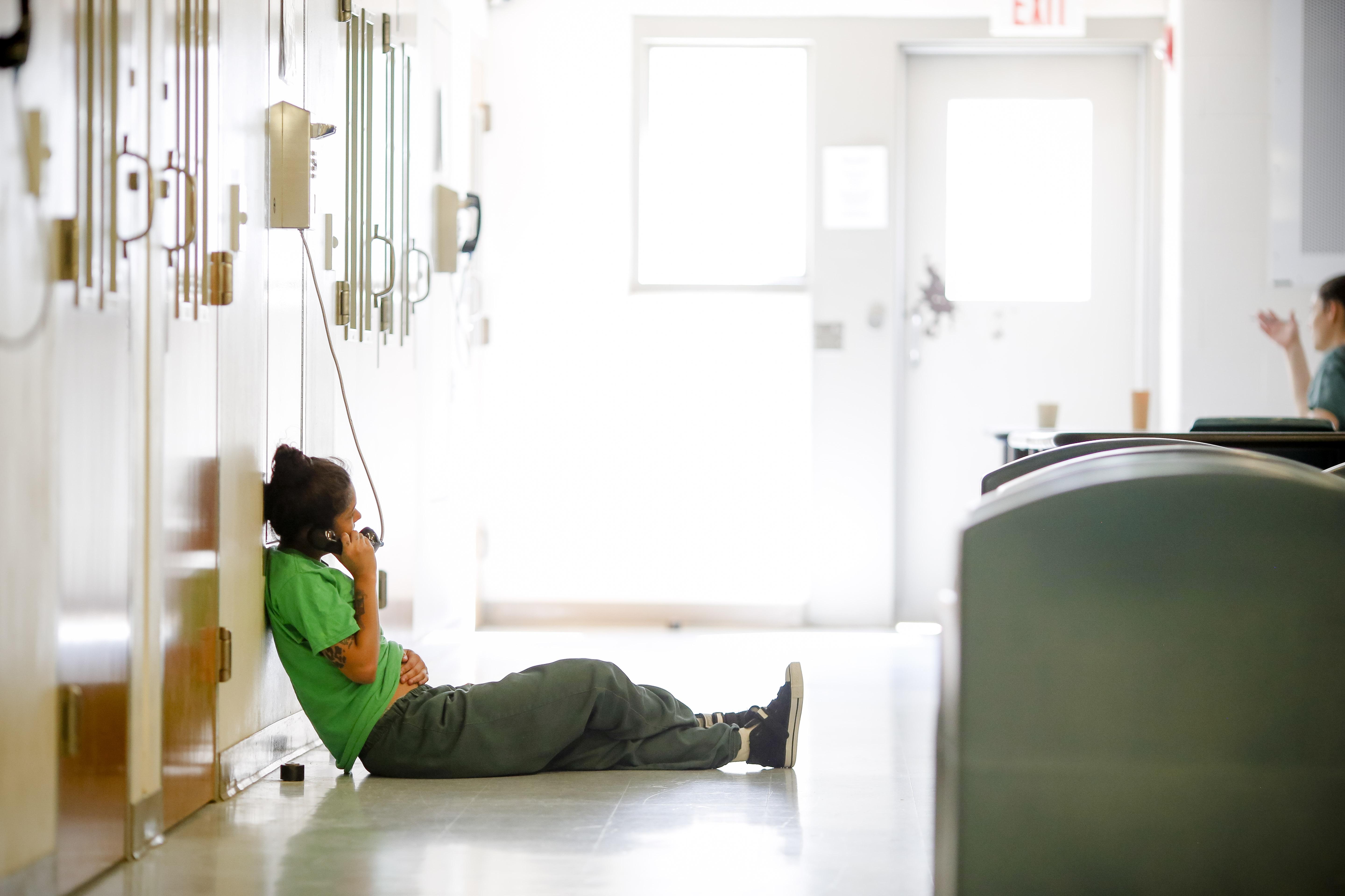 A woman at the Western Massachusetts Regional Women's Correctional Center speaks on the phone. Photo by Stephanie Zollshan for the Berkshire Eagle