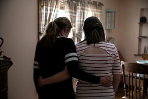 Barbara and Jessica pose for a portrait in the place in the living room where the incident with Elijah happened, on March 11, 2019, in Warwick, Rhode Island. Photo by Kayana Szymczak for ProPublica