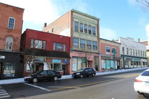 Small businesses including an upscale coffee shop have recently opened on Main Street, intermingling with crumbling buildings. Photo by Cassandra Basler for WSHU