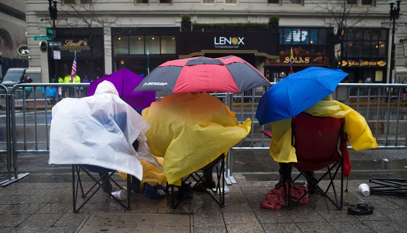 Spectators camped out in the wind and rain along Boylston St. Photo by Jesse Costa for WBUR