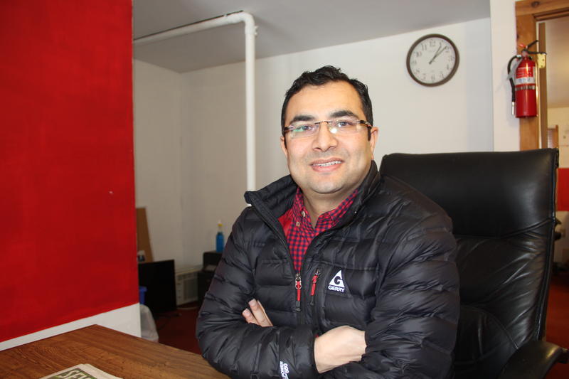 Bhuwan Sharma, co-owner of Burlington Employment Agency, at his Old North End office. He said his business has plateaued due in large part to Bhutanese-Nepali refugees moving from Vermont to Columbus, Ohio. Photo by Bayla Metzger for VPR