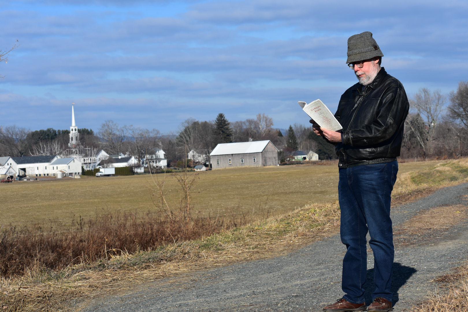 Forrest Proper reads from the anthology "Compass Roads" at an elbow of the Connecticut River in Hatfield, Massachusetts. Photo by Carrie Healy for NEPR