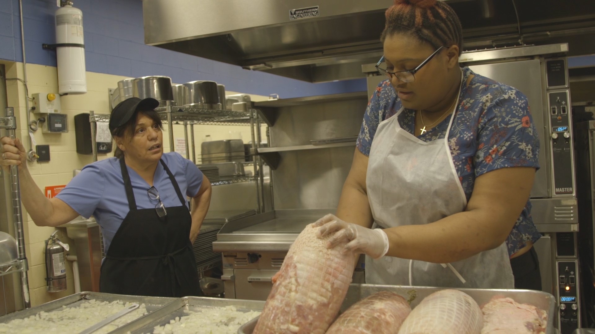 Cafeteria staff work overtime cooking raw turkey. Photo courtesy of Fiona Turner from the new documentary, "Eat Up"