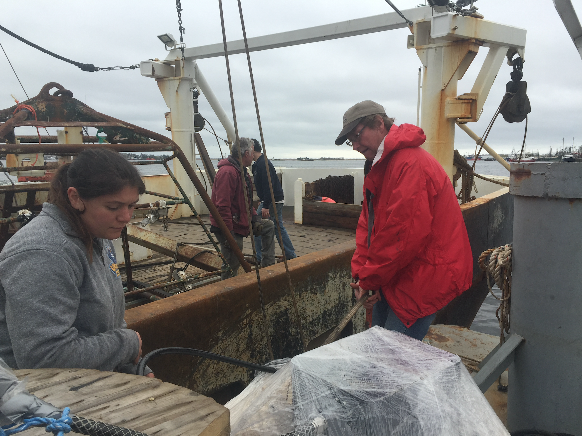 Dr. Kevin Stokebury, right, and his team on boat Liberty preparing for the last sea scallop survey before Vineyard Wind begins construction. Photo by Nadine Sebai for The Public's Radio