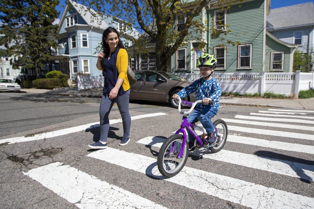 Elizabeth Pinsky walks along side of her son Ben while he rides his bicycle home along Elm St. in Somerville. Photo by Jesse Costa for WBUR